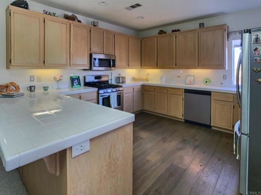 Interior, Kitchen, Recessed Lighting, Stainless Steel Appliances, Tile Countertops, Wood Texture Flooring
