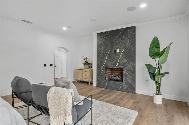 Fireplace, Interior, Marble Walls, Recessed Lighting, Wood Texture Flooring