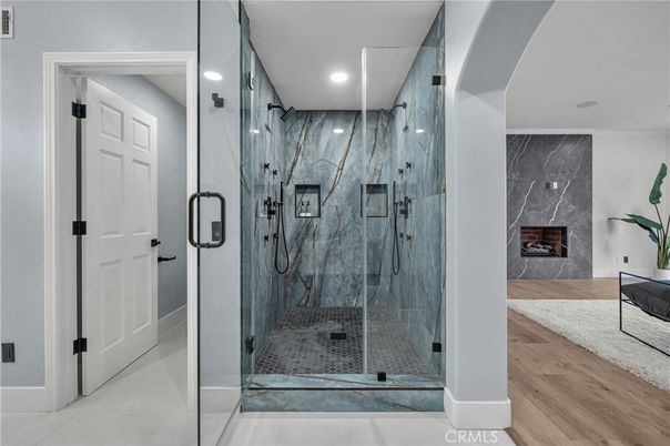 Bathroom, Fireplace, Glass Shower, Interior, Marble Walls, Recessed Lighting, Wood Texture Flooring