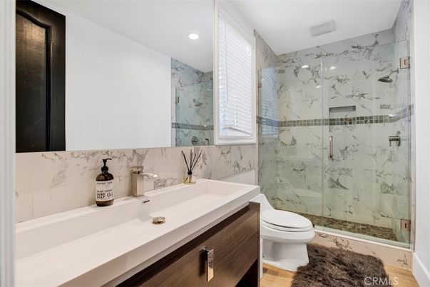 Bathroom, Glass Shower, Interior, Marble Walls, Recessed Lighting, Wood Texture Flooring