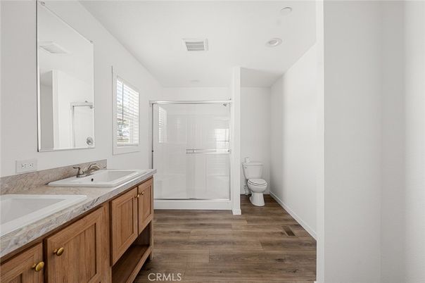 Bathroom, Dual Sink Vanities, Glass Shower, Interior, Recessed Lighting, Wood Texture Flooring