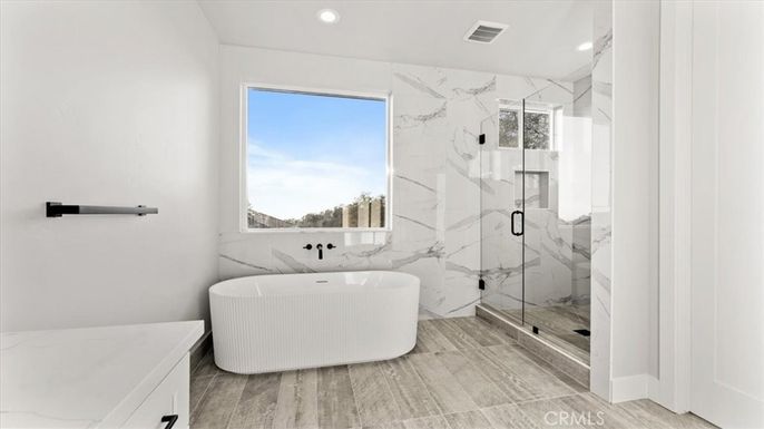 Bathroom, Free Standing Baths, Glass Shower, Interior, Marble Walls, Recessed Lighting, Wood Texture Flooring