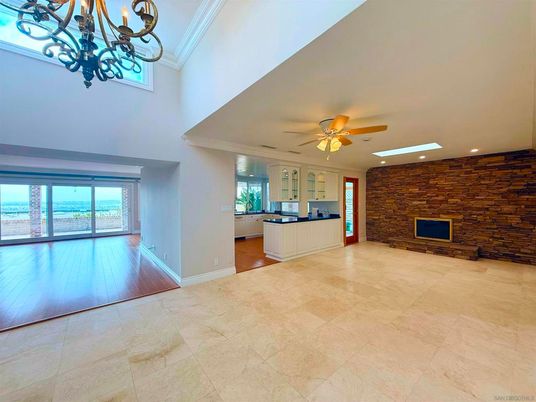 Chandelier, Empty room, Fireplace, Interior, Recessed Lighting, Stone Walls, Wood Texture Flooring