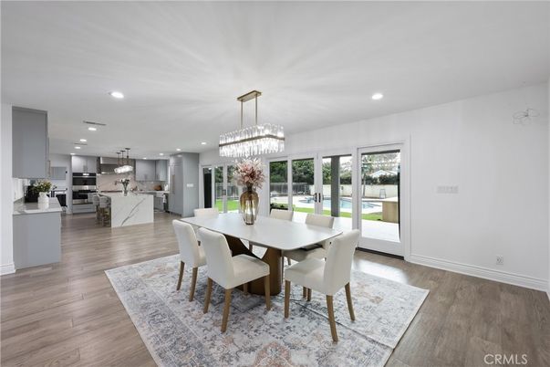 Chandelier, Dining room, Interior, Kitchen, Pendant Lights, Recessed Lighting, Stainless Steel Appliances, Wood Texture Flooring