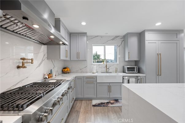 Interior, Kitchen, Marble Walls, Recessed Lighting, Stainless Steel Appliances, Wood Texture Flooring