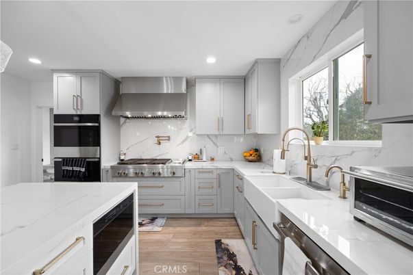 Interior, Kitchen, Marble Walls, Recessed Lighting, Stainless Steel Appliances, Wood Texture Flooring
