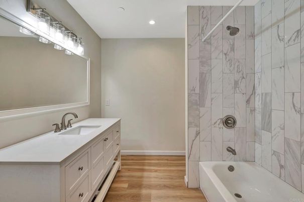 Bathroom, Dual Sink Vanities, Interior, Marble Walls, Recessed Lighting, Wood Texture Flooring
