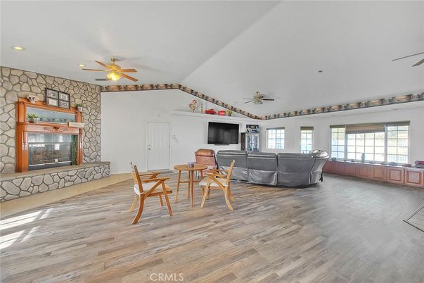 Fireplace, Interior, Living room, Recessed Lighting, Stone Walls, Wood Texture Flooring