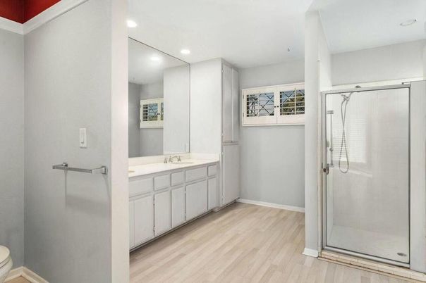 Bathroom, Dual Sink Vanities, Glass Shower, Interior, Recessed Lighting, Wood Texture Flooring