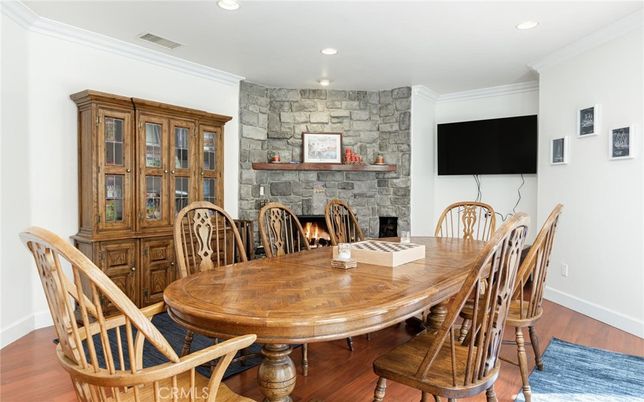 Dining room, Fireplace, Interior, Recessed Lighting, Stone Walls, Wood Texture Flooring
