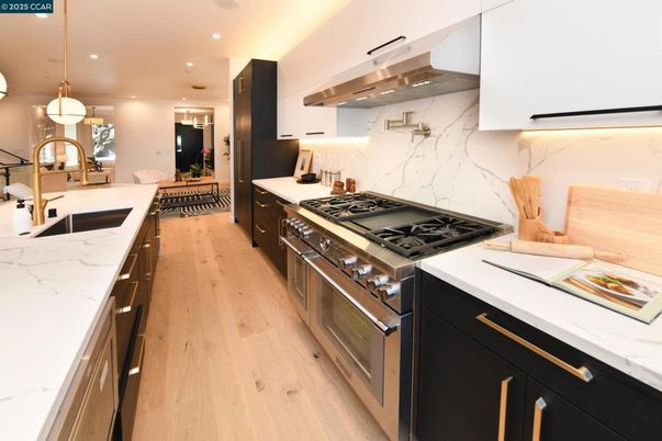Interior, Kitchen, Marble Walls, Pendant Lights, Recessed Lighting, Stainless Steel Appliances, Wood Texture Flooring