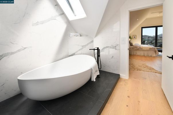 Bathroom, Free Standing Baths, Interior, Marble Walls, Recessed Lighting, Wood Texture Flooring