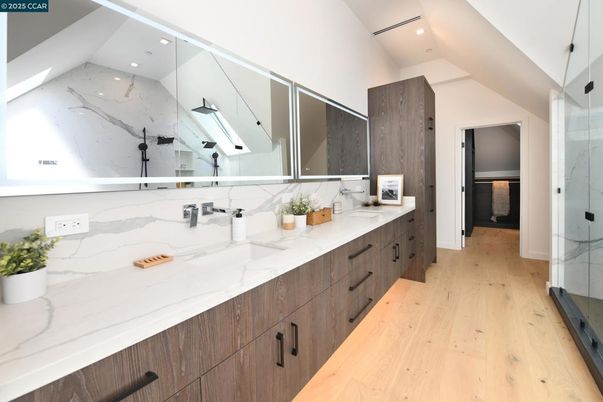 Bathroom, Dual Sink Vanities, Glass Shower, Interior, Marble Walls, Recessed Lighting, Wood Texture Flooring