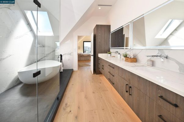 Bathroom, Dual Sink Vanities, Free Standing Baths, Glass Shower, Interior, Marble Walls, Recessed Lighting, Wood Texture Flooring