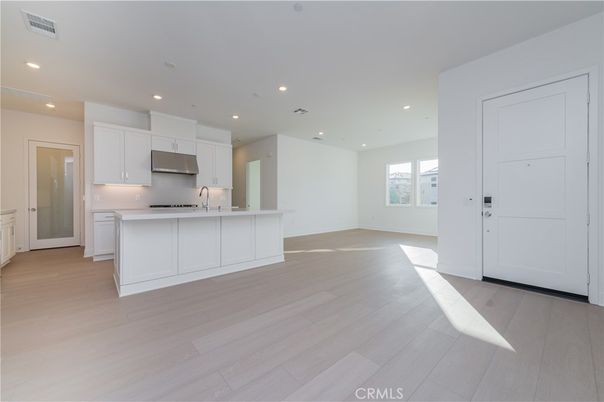 Empty room, Interior, Kitchen, Recessed Lighting, Stainless Steel Appliances, Wood Texture Flooring