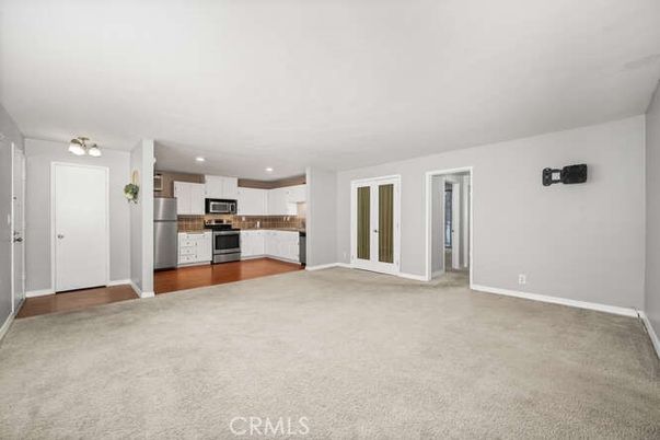 Empty room, Interior, Kitchen, Recessed Lighting, Stainless Steel Appliances, Wood Texture Flooring