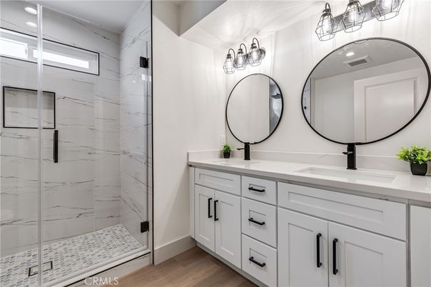 Bathroom, Dual Sink Vanities, Glass Shower, Interior, Marble Walls, Wood Texture Flooring
