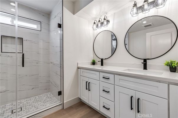 Bathroom, Dual Sink Vanities, Glass Shower, Interior, Marble Walls, Wood Texture Flooring