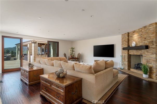 Dining room, Fireplace, Interior, Living room, Recessed Lighting, Stone Walls, Wood Texture Flooring