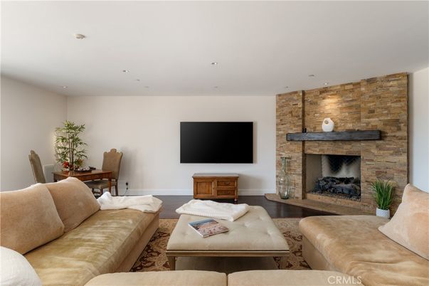 Dining room, Fireplace, Interior, Living room, Recessed Lighting, Stone Walls, Wood Texture Flooring