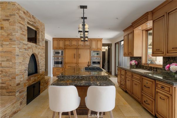 Fireplace, Interior, Kitchen, Pendant Lights, Recessed Lighting, Stainless Steel Appliances, Stone Walls