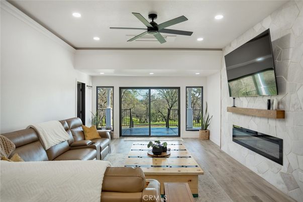 Fireplace, Interior, Living room, Recessed Lighting, Stone Walls, Wood Texture Flooring