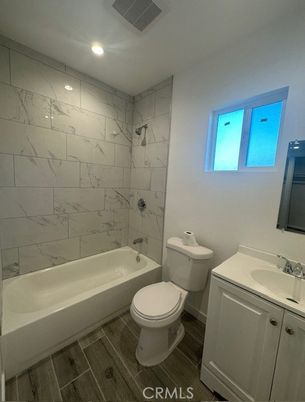 Bathroom, Dual Sink Vanities, Interior, Marble Walls, Recessed Lighting, Wood Texture Flooring