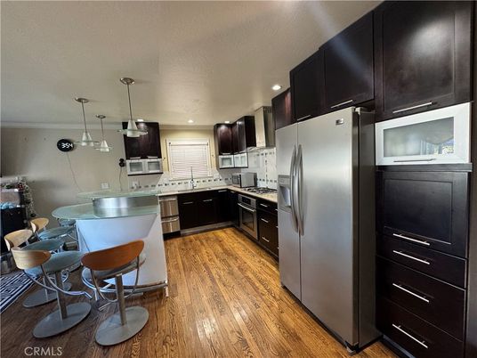 Dining room, Interior, Kitchen, Pendant Lights, Recessed Lighting, Stainless Steel Appliances, Wood Texture Flooring