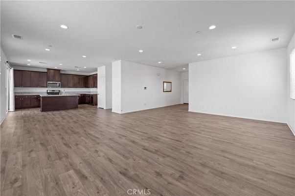 Empty room, Interior, Kitchen, Recessed Lighting, Stainless Steel Appliances, Wood Texture Flooring