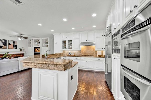 Fireplace, Interior, Kitchen, Living room, Recessed Lighting, Stainless Steel Appliances, Wood Texture Flooring
