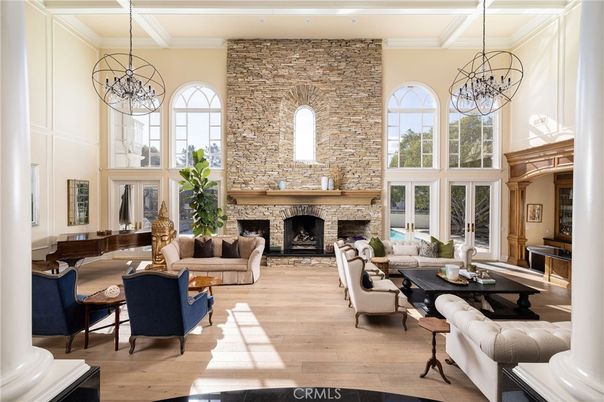 Chandelier, Fireplace, Interior, Living room, Pendant Lights, Recessed Lighting, Stone Walls, Wood Texture Flooring