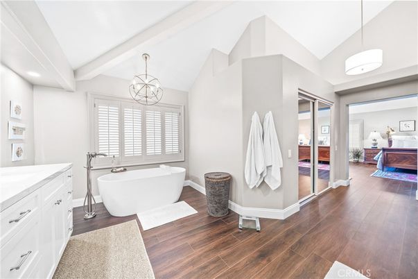 Bathroom, Chandelier, Free Standing Baths, Interior, Pendant Lights, Recessed Lighting, Wood Texture Flooring