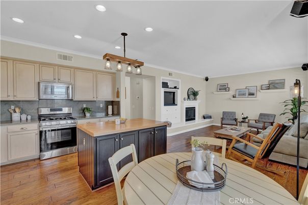 Dining room, Fireplace, Interior, Kitchen, Living room, Pendant Lights, Recessed Lighting, Stainless Steel Appliances, Wood Texture Flooring