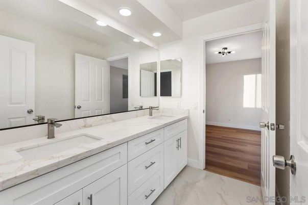 Bathroom, Dual Sink Vanities, Interior, Marble, Recessed Lighting, Wood Texture Flooring