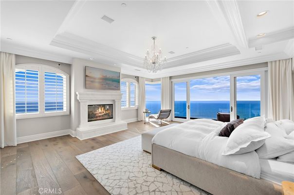 Bedroom, Chandelier, Fireplace, Interior, Recessed Lighting, Water, Wood Texture Flooring