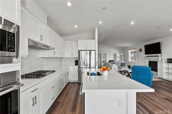 Dining room, Fireplace, Interior, Kitchen, Living room, Recessed Lighting, Stainless Steel Appliances, Wood Texture Flooring
