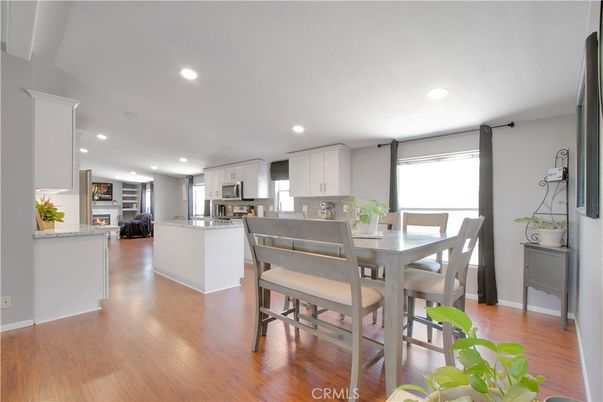 Dining room, Fireplace, Interior, Kitchen, Recessed Lighting, Stainless Steel Appliances, Wood Texture Flooring