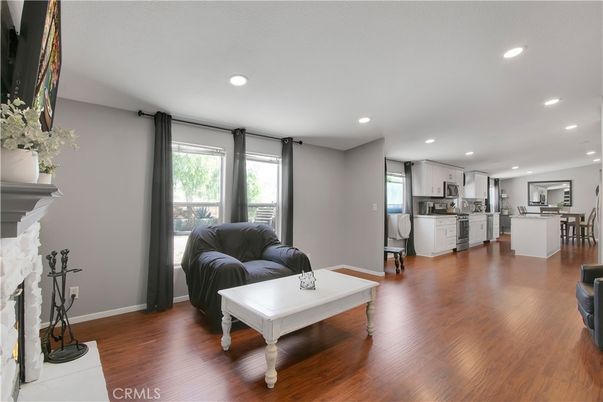 Dining room, Fireplace, Interior, Kitchen, Recessed Lighting, Stainless Steel Appliances, Wood Texture Flooring