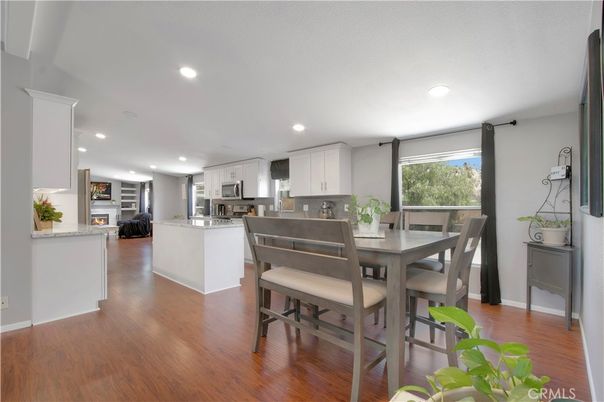 Dining room, Fireplace, Interior, Kitchen, Recessed Lighting, Stainless Steel Appliances, Wood Texture Flooring