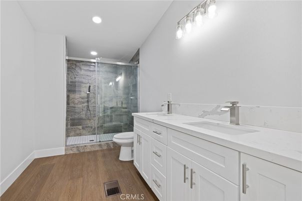Bathroom, Dual Sink Vanities, Glass Shower, Interior, Recessed Lighting, Wood Texture Flooring