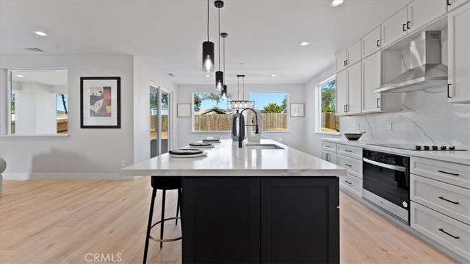 Interior, Kitchen, Marble Walls, Pendant Lights, Recessed Lighting, Stainless Steel Appliances, Wood Texture Flooring