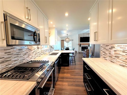 Chandelier, Dining room, Interior, Kitchen, Pendant Lights, Recessed Lighting, Stainless Steel Appliances, Wood Texture Flooring
