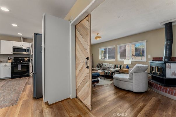 Fireplace, Interior, Kitchen, Living room, Pendant Lights, Recessed Lighting, Stainless Steel Appliances, Wood Texture Flooring