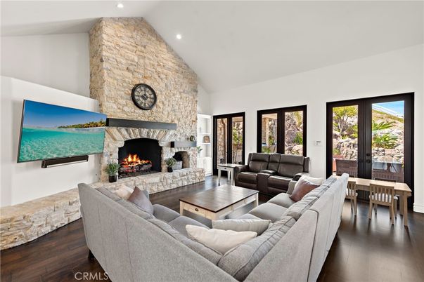 Dining room, Fireplace, Interior, Living room, Recessed Lighting, Stone Walls, Wood Texture Flooring