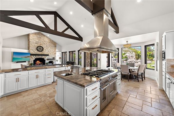Dining room, Fireplace, Interior, Kitchen, Living room, Pendant Lights, Recessed Lighting, Stainless Steel Appliances, Stone Walls, Wooden Beams