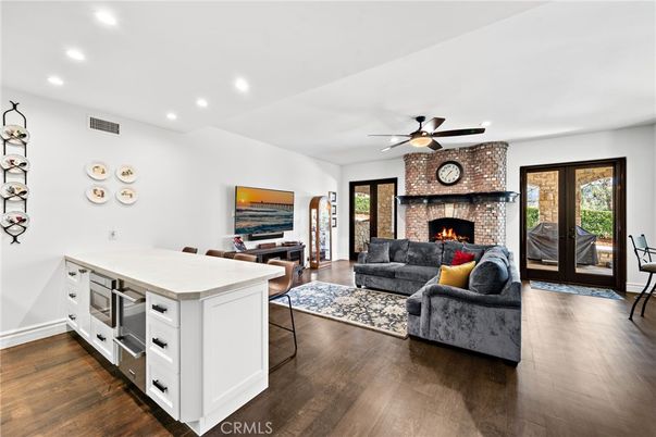 Dining room, Fireplace, Interior, Kitchen, Living room, Recessed Lighting, Stone Walls, Wood Texture Flooring