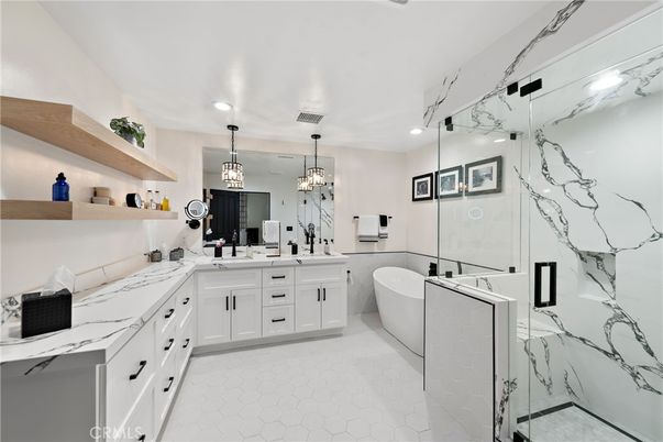 Bathroom, Chandelier, Dual Sink Vanities, Free Standing Baths, Glass Shower, Interior, Marble Walls, Pendant Lights, Recessed Lighting