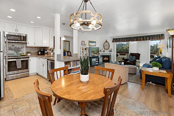 Chandelier, Dining room, Fireplace, Interior, Kitchen, Living room, Pendant Lights, Recessed Lighting, Stainless Steel Appliances, Wood Texture Flooring