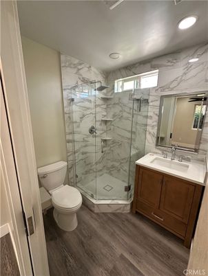 Bathroom, Glass Shower, Interior, Marble Walls, Recessed Lighting, Wood Texture Flooring