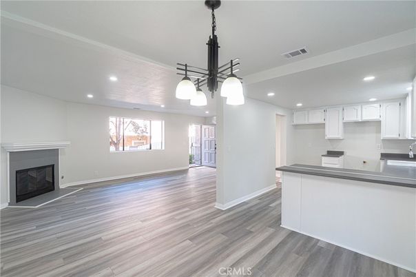 Empty room, Fireplace, Interior, Kitchen, Pendant Lights, Recessed Lighting, Wood Texture Flooring